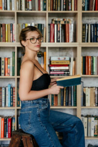 Blonde camgirl with glasses AdelinaDelvi reading book